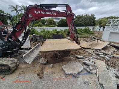 Yanmar excavator lifting broken concrete slab