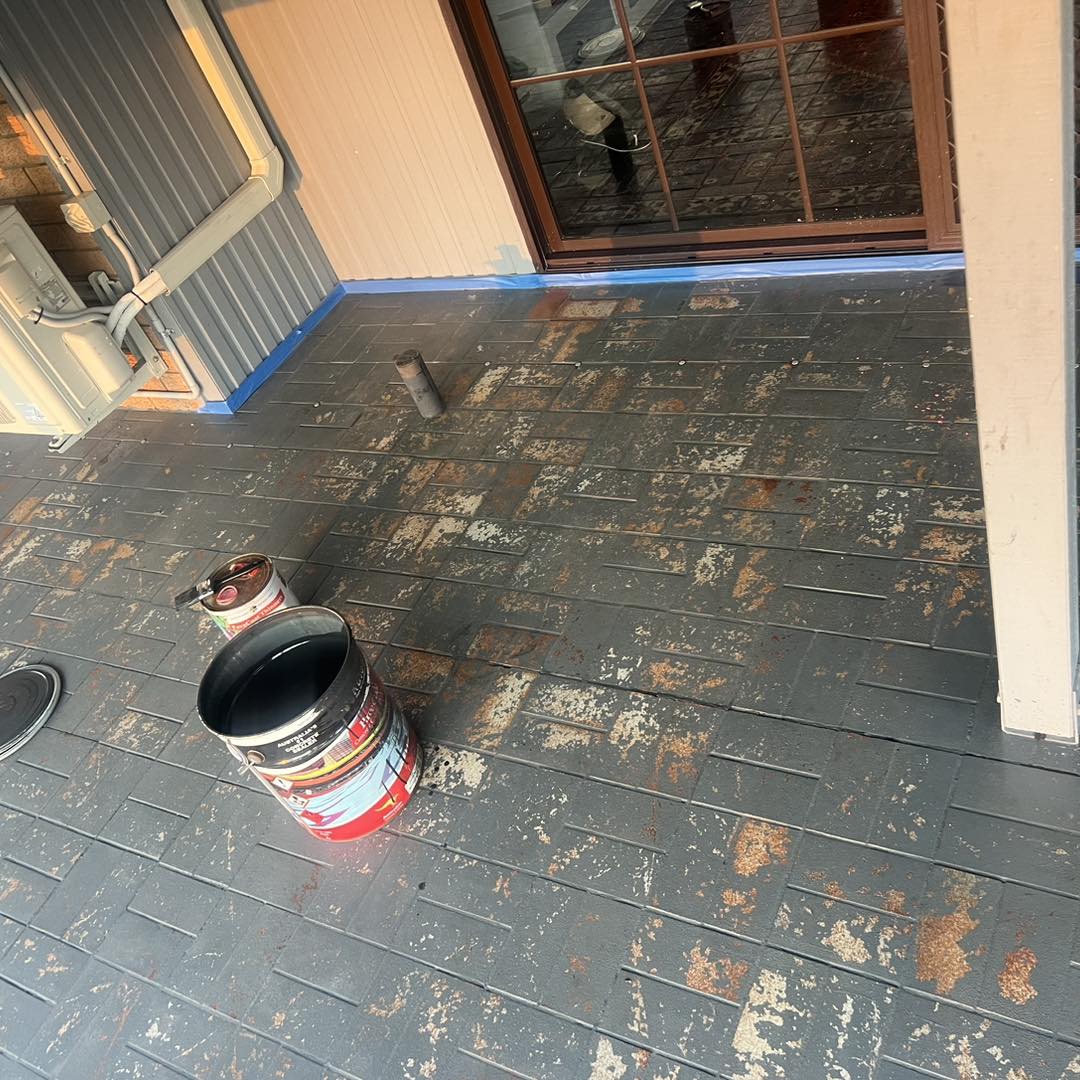 Applying sealer to stencil concrete patio