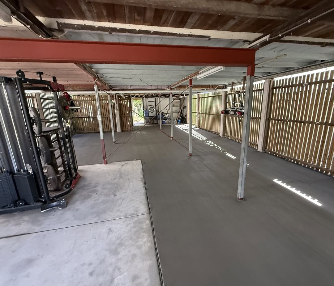 Freshly poured slab with broom finish under raised house
